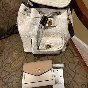 Brand new never used coach backpack and matching wallet.